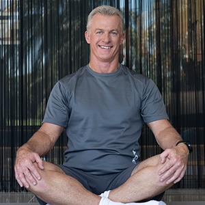 Man practicing pelvic floor exercises for men on a mat