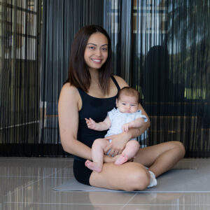 New mum posing with beautiful baby during pelvic floor exercises