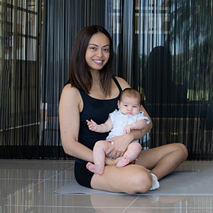 New mum posing with her baby during pelvic floor exercises
